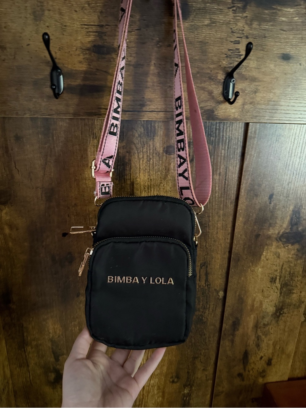 BIMBA Y LOLA Black Crossbody Phone Bag with Pink Branded Strap